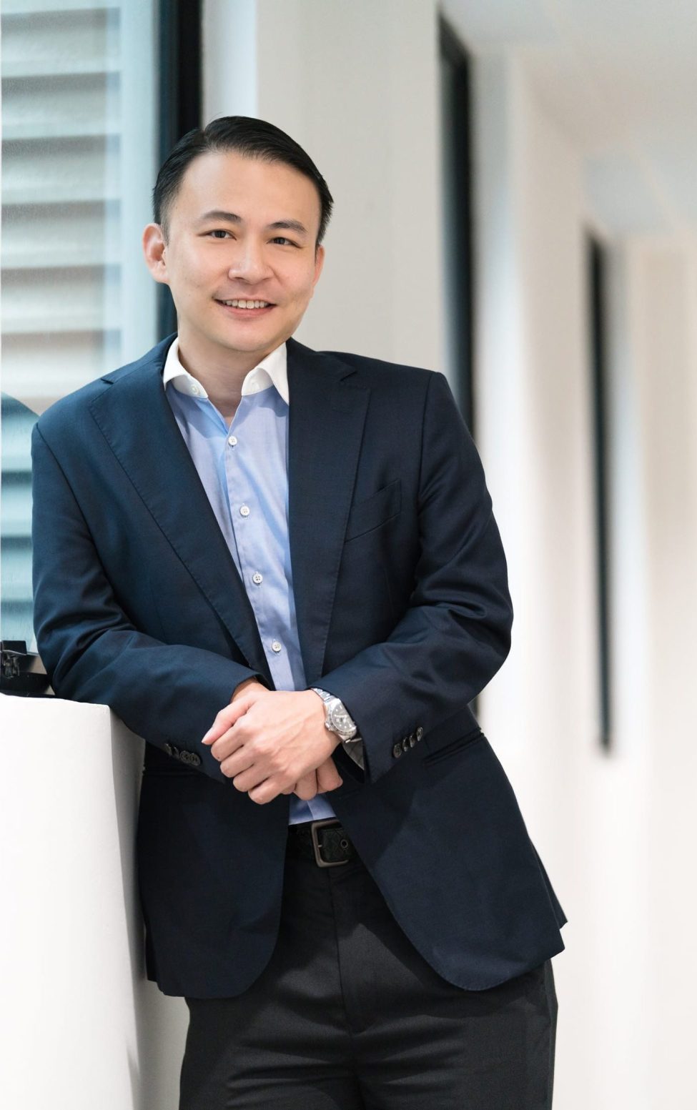 A man in a formal business suit poses for his headshot in an office setting during a corporate photoshoot in Singapore Credit: White Room Studio, 219 River Valley Road Singapore