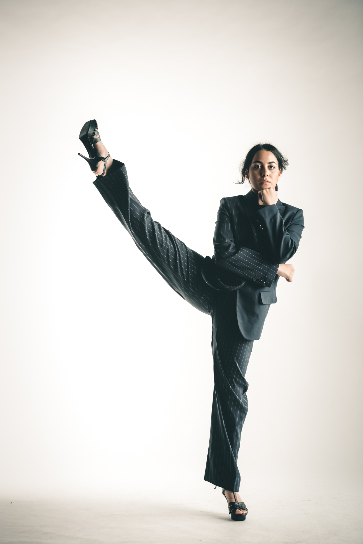 A woman dancer poses with one leg up during a personal branding photo shoot in Singapore