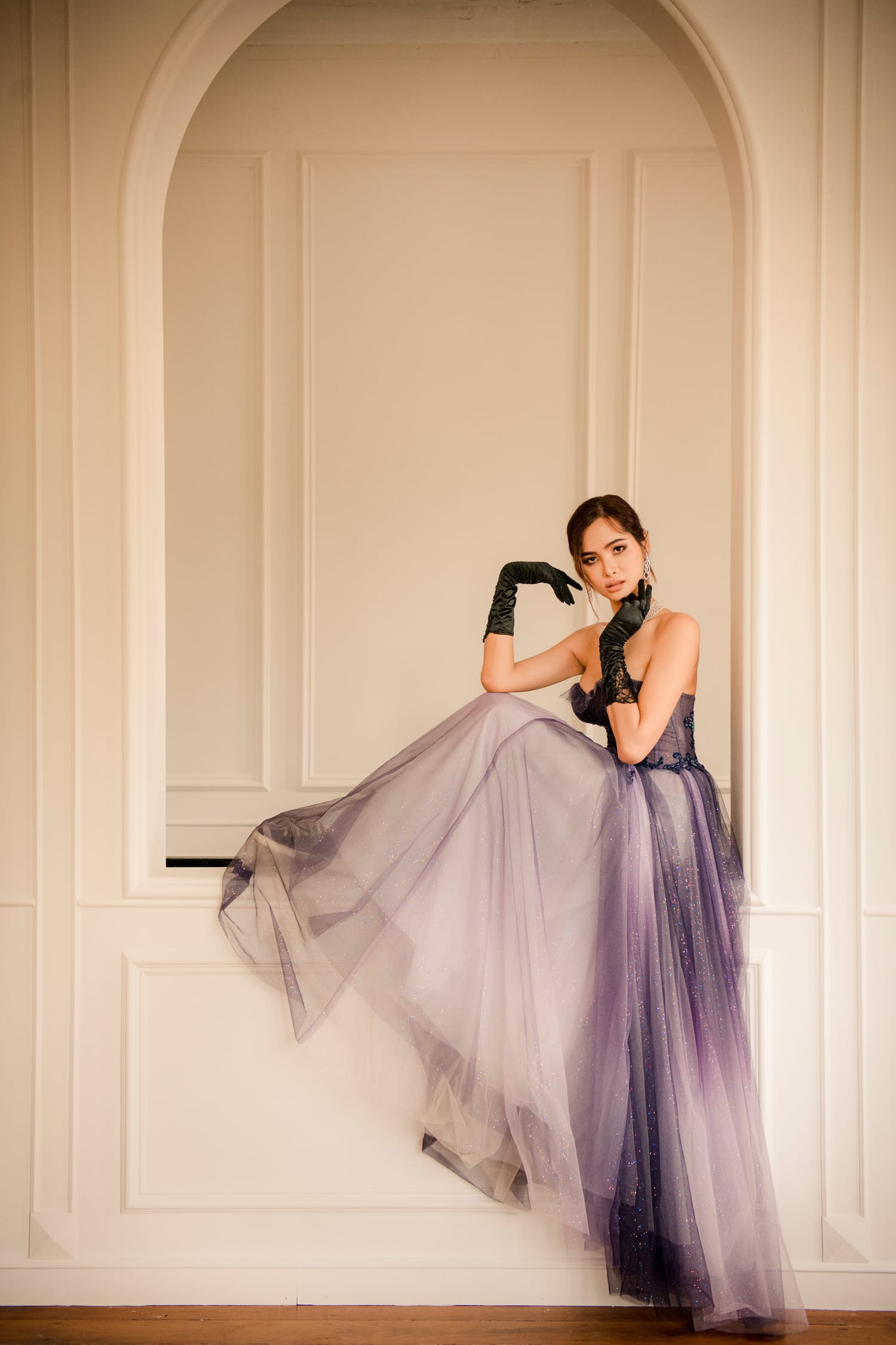 A woman in a ball gown dress and gloves posing for a portrait during a professional personal branding photoshoot in Singapore