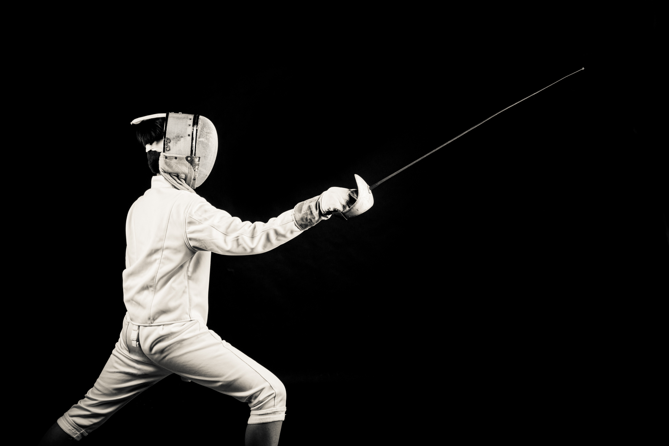 Professional fencer fencing in a photography studio setting during a corporate photoshoot in Singapore, White Room Studio. Credit: White Room Studio Pte Ltd