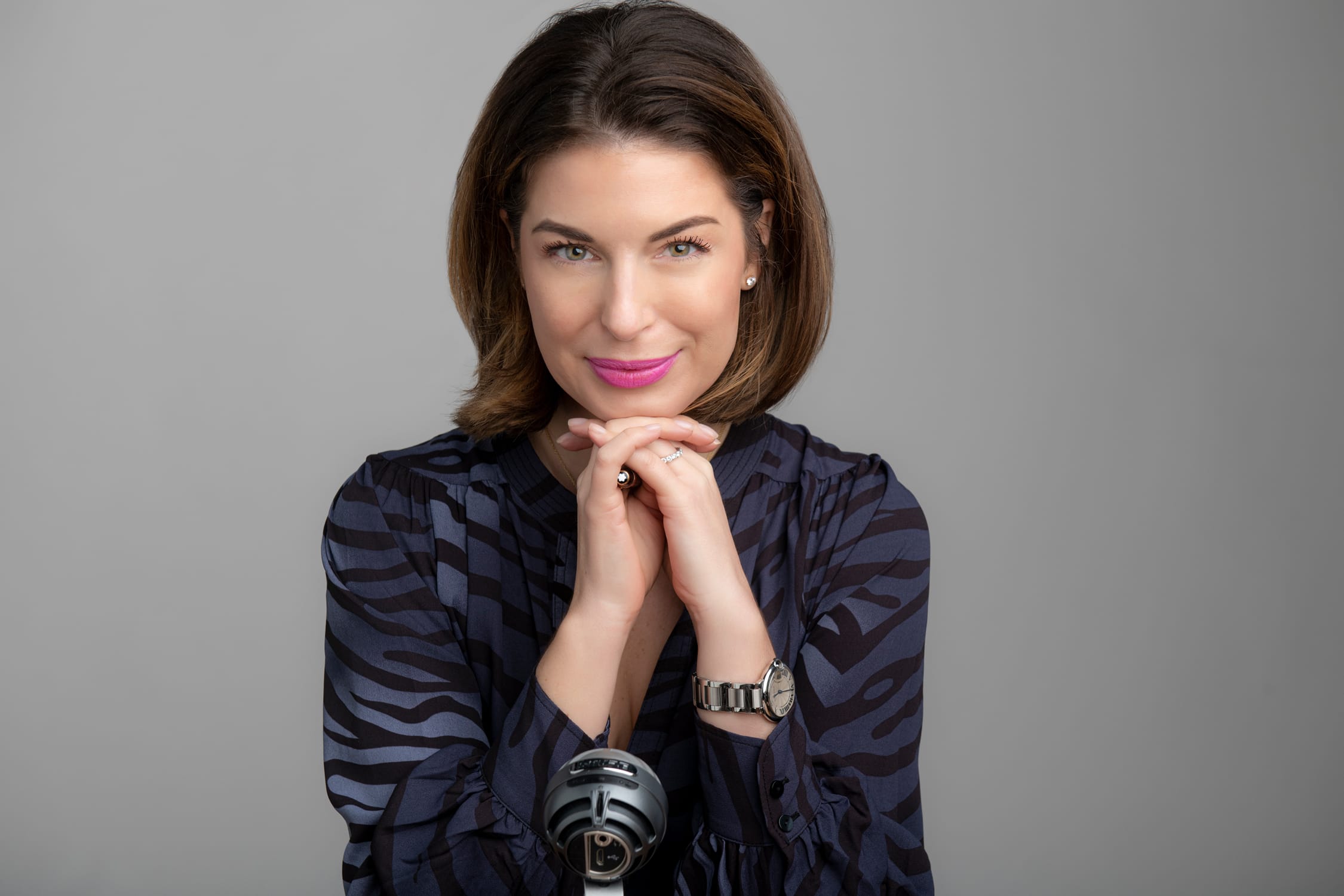 A woman posing for a professional LinkedIn headshot against a grey studio background during a corporate photoshoot in Singapore Credit: White Room Studio