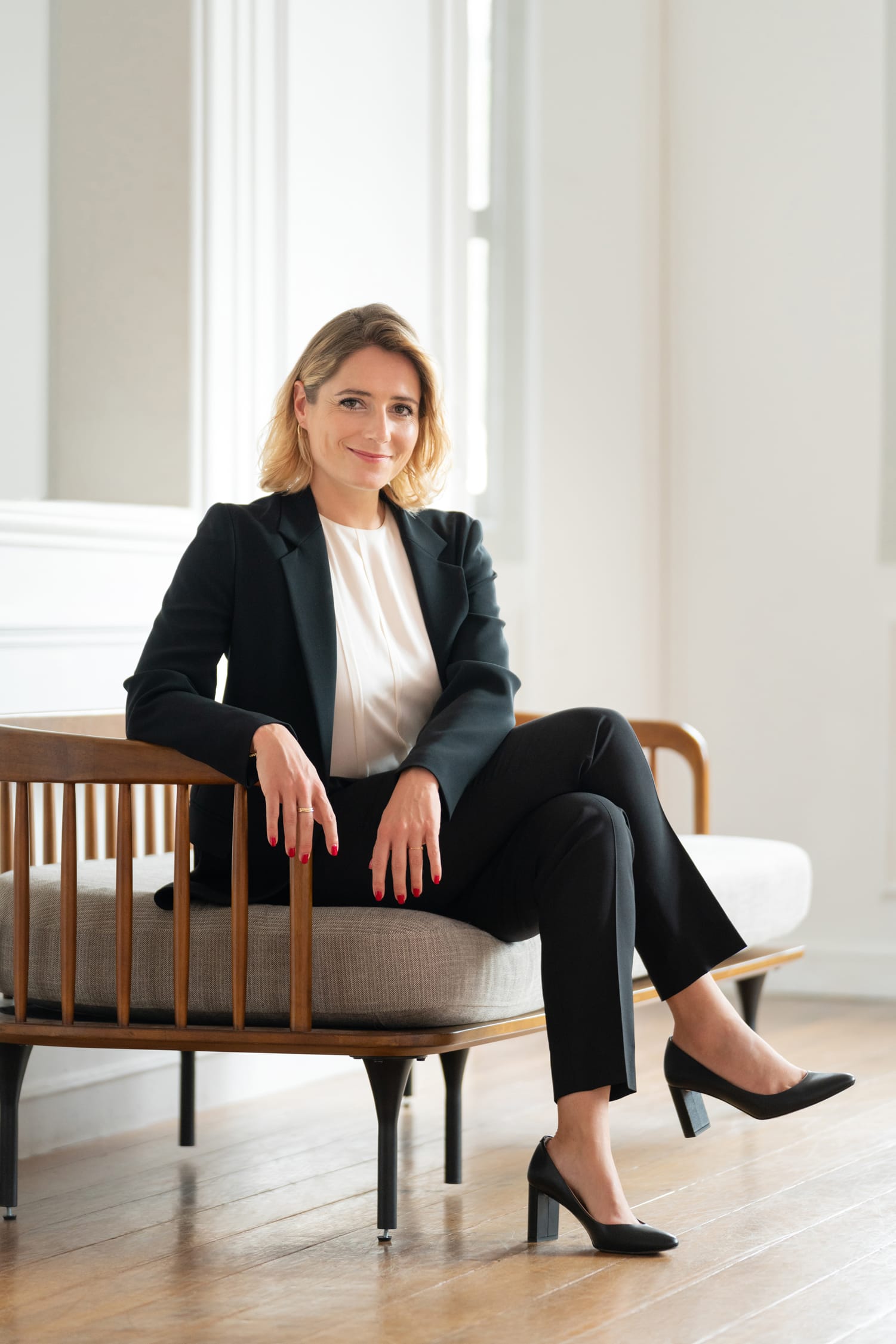 A woman in a formal blazer posing for a headshot under natural light during a corporate photoshoot in Singapore Credit: White Room Studio