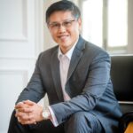 Man in a business suit posing for headshot in a photography studio setting during a corporate photoshoot in Singapore, White Room Studio. Credit: White Room Studio Pte Ltd