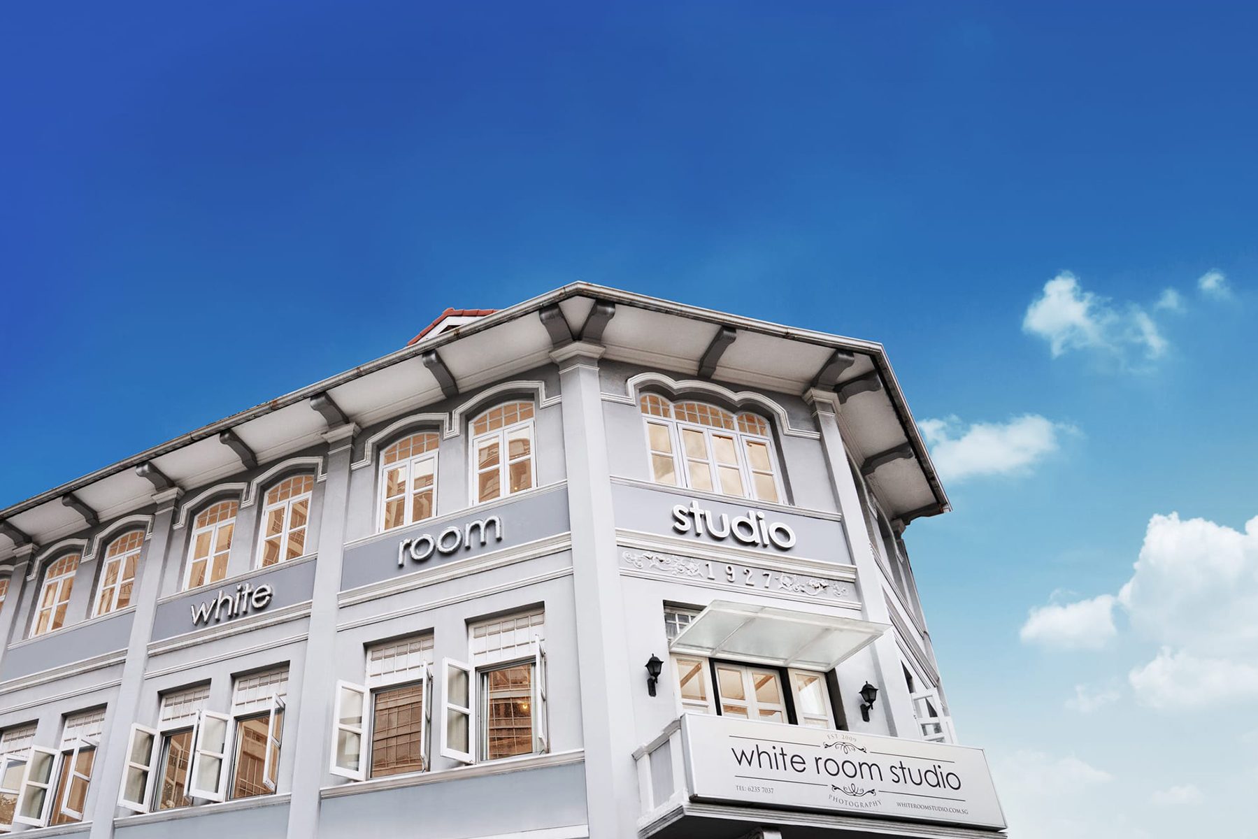A two-storey shophouse photography studio in River Valley, Singapore taken against a blue sky Credit: White Room Studio