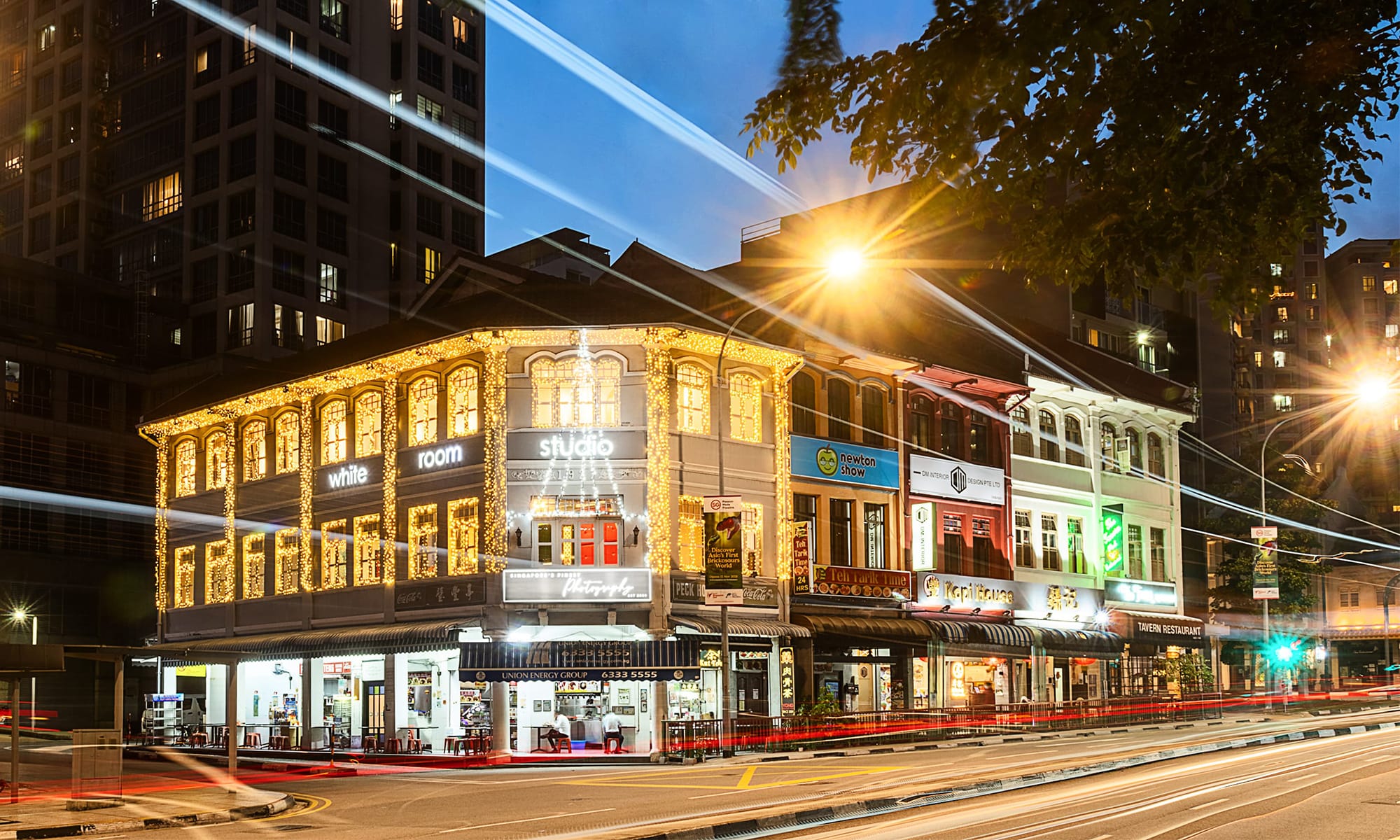 Long exposure photo of a photography studio Peranakan shophouse during dusk with Christmas lights along River Valley Road, Singapore. Credit: White Room Studio Pte Ltd