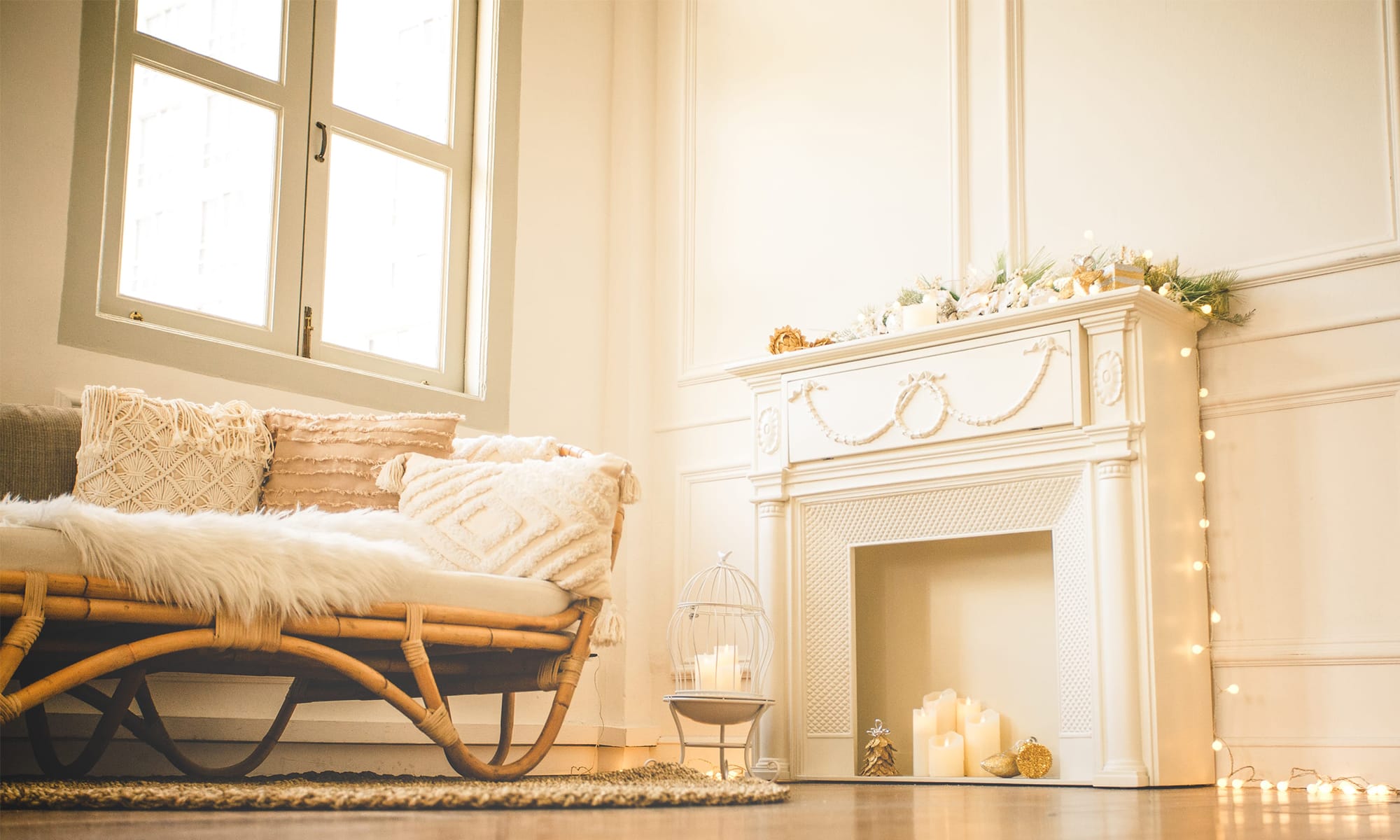 A photography studio space with white walls with wainscoting, and tall windows with natural sunlight with fireplace and candles in River Valley, Singapore Credit: White Room Studio