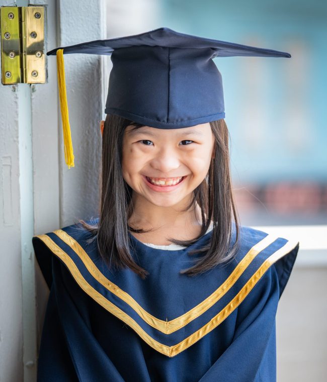 Girl in K2 kindergarten graduation gown and cap during a k2 kindergarten graduation photoshoot in Singapore Credit: White Room Studio