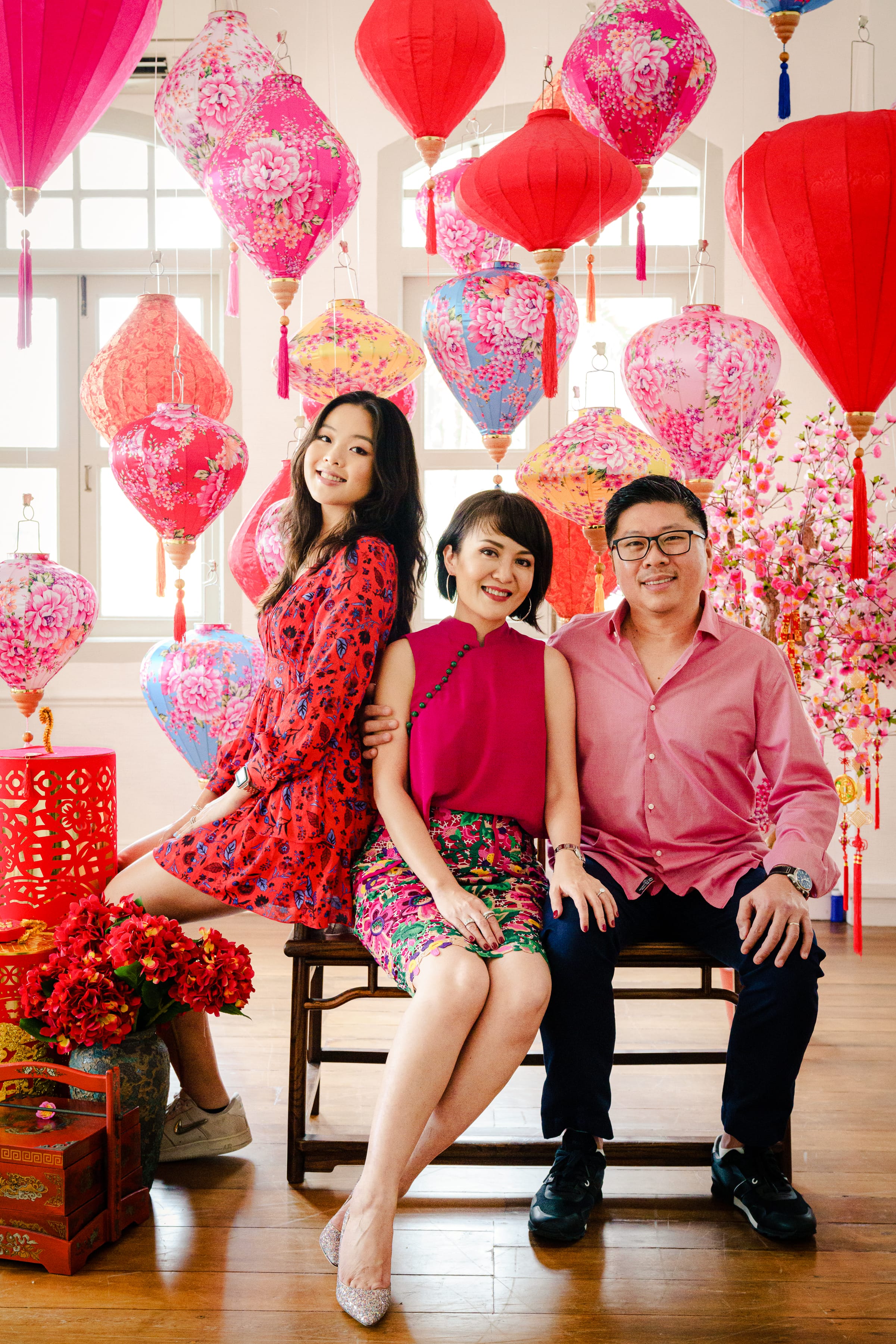 Family with parents and their daughter in a photography studio setting during a Chinese New Year family photoshoot in Singapore, White Room Studio. Credit: White Room Studio Pte Ltd