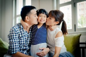Family with parents and daughter in a photography studio setting during a Chinese New Year family photoshoot in Singapore, White Room Studio. Credit: White Room Studio Pte Ltd