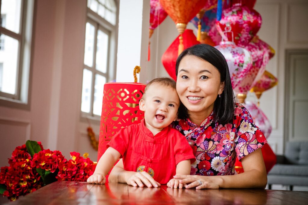 Mother and toddler baby boy in Chinese New Year outfits during a professional Chinese New Year family photoshoot in Singapore Credit: White Room Studio