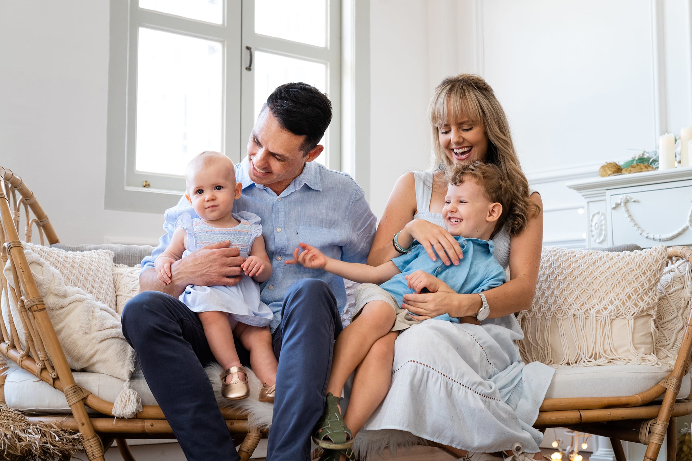 Professional Family & Multi Generation Photoshoot in Photography Studio, Singapore Family with parents hugging two children in a photography studio setting during a family and kids photoshoot in Singapore, White Room Studio. Credit: White Room Studio Pte Ltd
