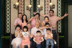 Family with parents and their children with kids ages ranging from toddler to teens in a Peranakan photography studio setting during a family and kids photoshoot in Singapore, White Room Studio. Credit: White Room Studio Pte Ltd