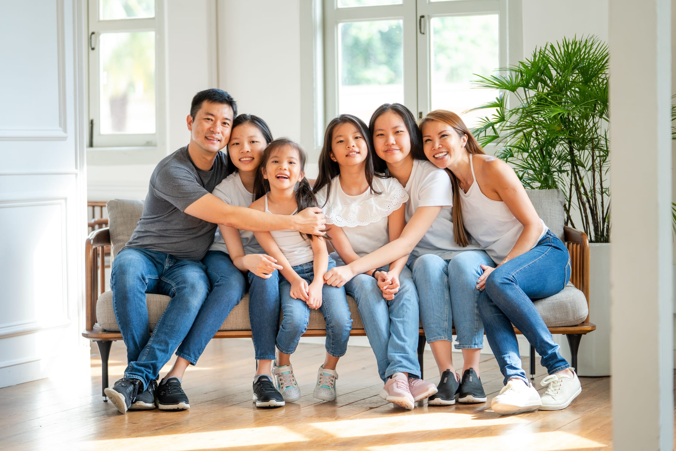 Family with parents and their children with kids ages ranging from toddler to teens in a photography studio setting during a family and kids photoshoot in Singapore, White Room Studio. Credit: White Room Studio Pte Ltd