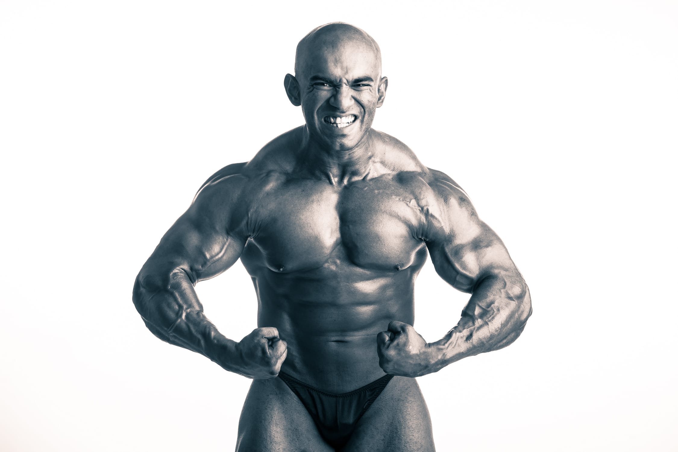 Man (bodybuilder) posing for body profile photo in a photography studio setting during a body profile photoshoot in Singapore, White Room Studio Credit: White Room Studio