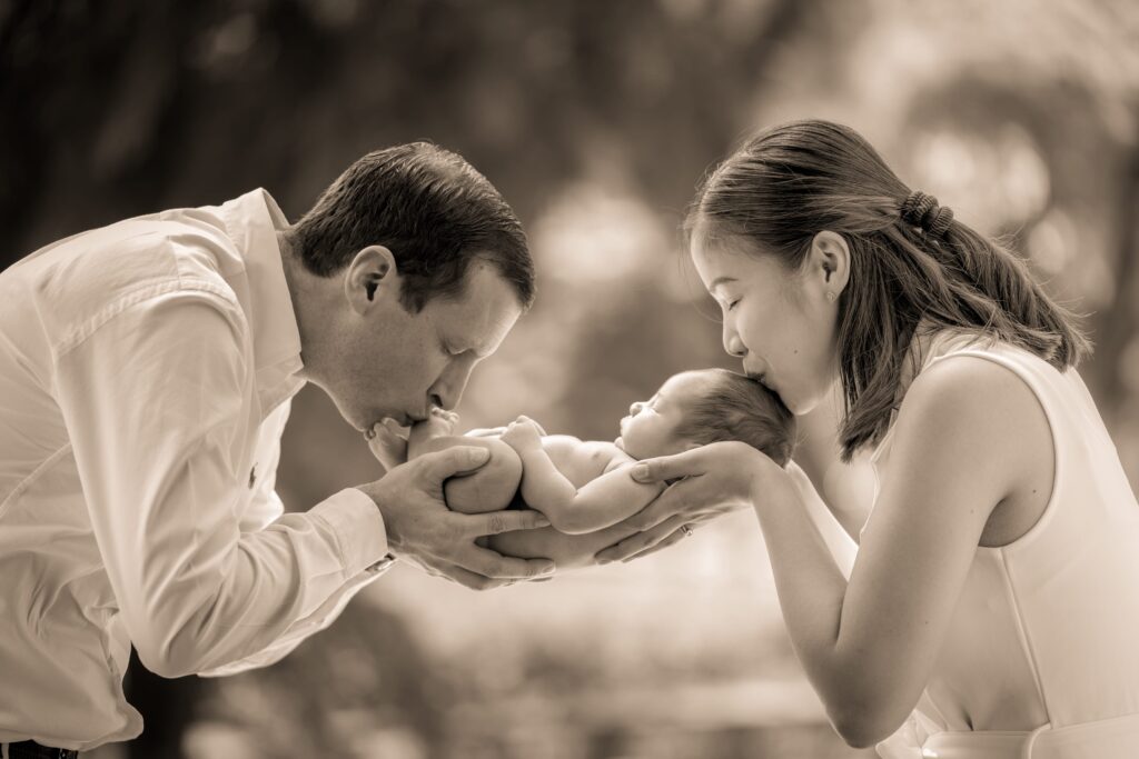 Professional Family & Newborn Photoshoot in Photography Studio, Singapore Family with parents and their newborn baby in a photography studio setting during a newborn photoshoot in Singapore, White Room Studio. Credit: White Room Studio Pte Ltd