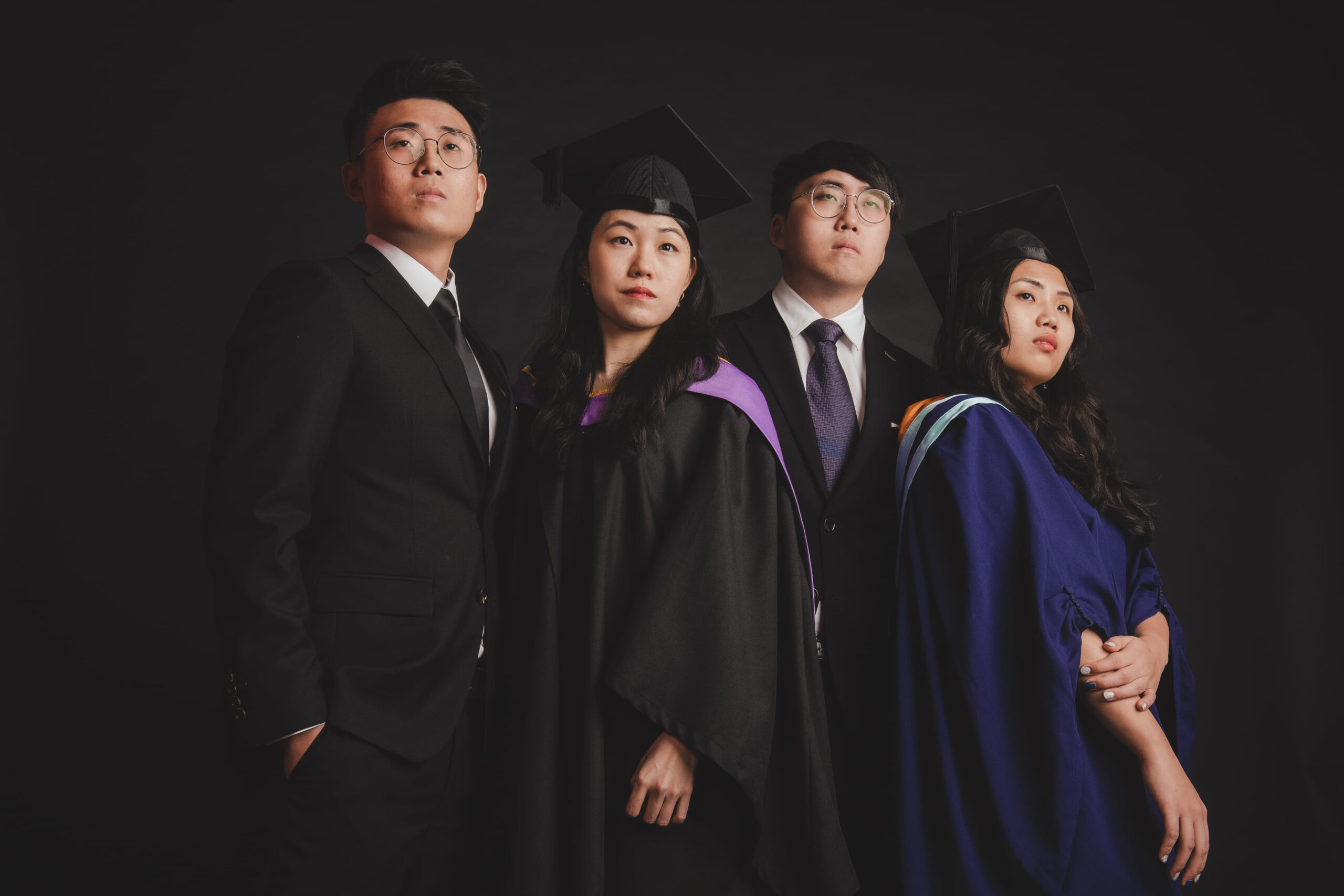 Professional Family & Multi Generation Photoshoot in Photography Studio, Singapore Family with parents and their children in a graduation gown and cap within a photography studio setting during a graduation photoshoot in Singapore, White Room Studio. Credit: White Room Studio Pte Ltd