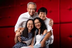 Family with parents and their children in a photography studio setting during a family and graduation photoshoot in Singapore, White Room Studio. Credit: White Room Studio Pte Ltd