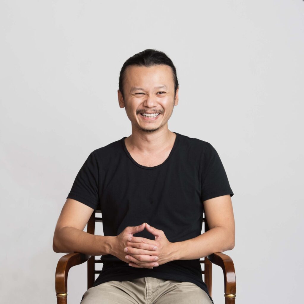 Professional Family Photographer in White Room Studio, Singapore Portrait of a man in a photography studio setting during a personal portrait photoshoot in Singapore, White Room Studio. Credit: White Room Studio Pte Ltd