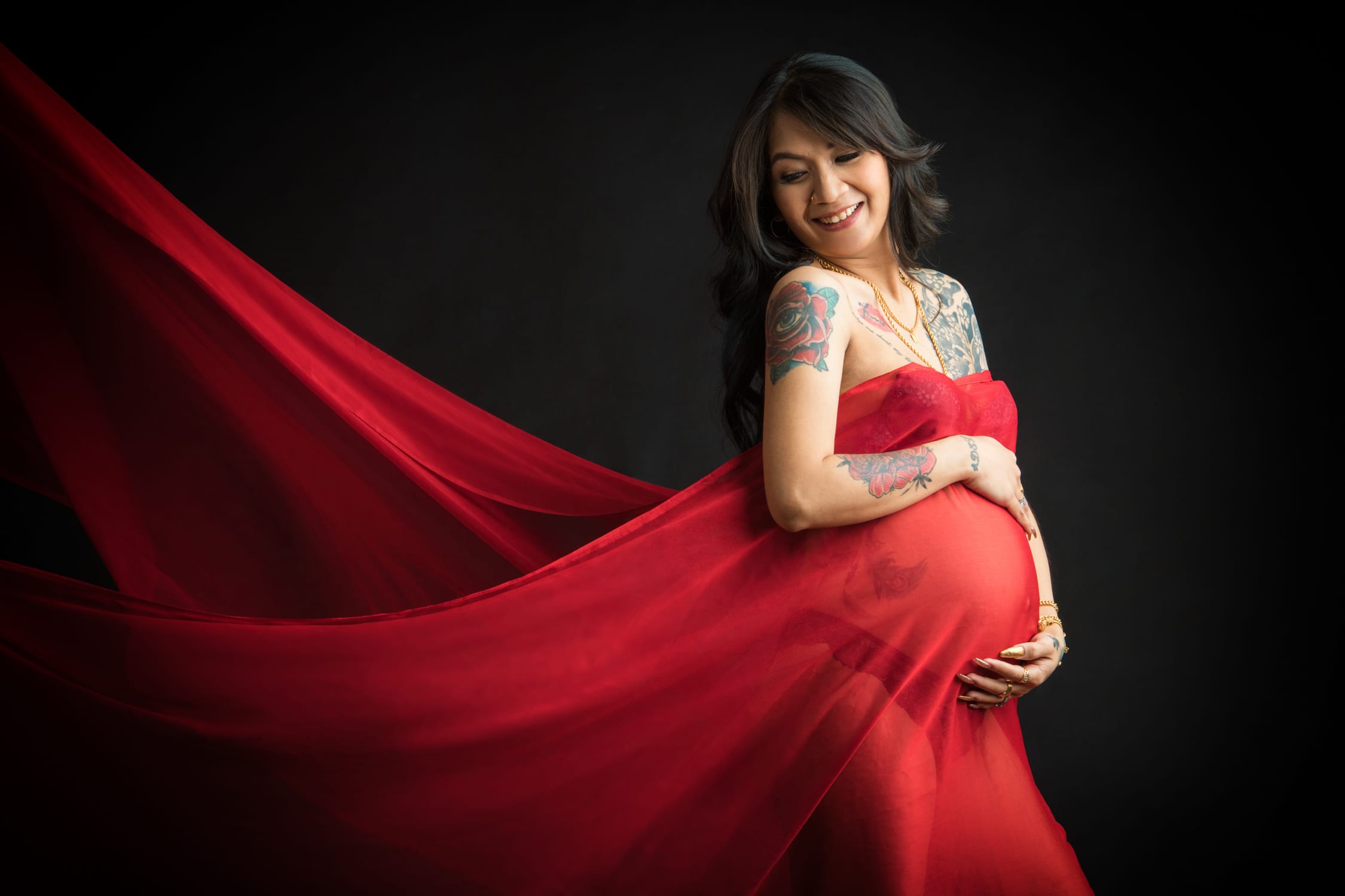 Pregnant mother, mother-to-be with baby bump in a photography studio setting during a maternity photoshoot in Singapore, White Room Studio. Credit: White Room Studio Pte Ltd