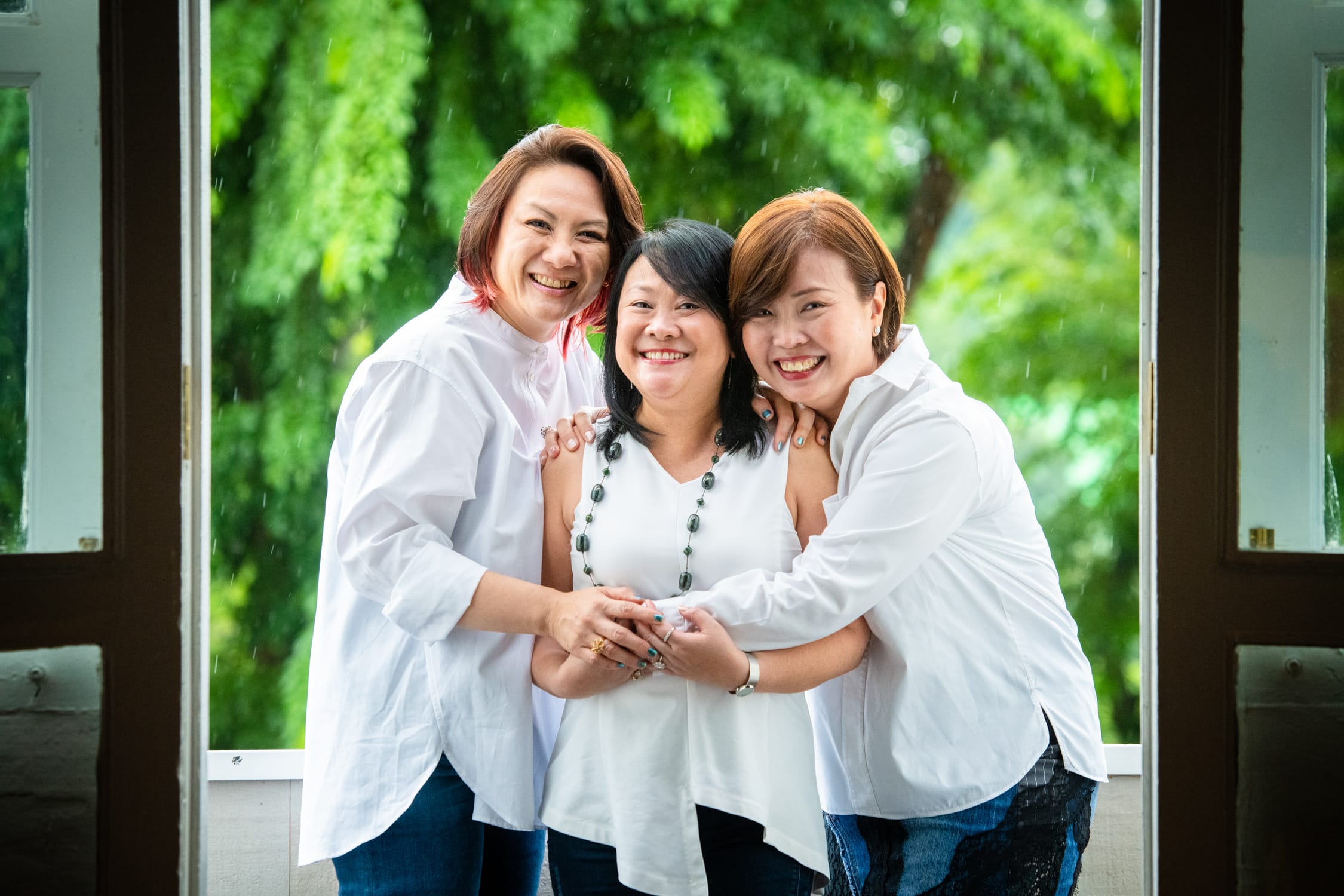 Friends in a photography studio setting during a glamour photoshoot in Singapore, White Room Studio. Credit: White Room Studio Pte Ltd