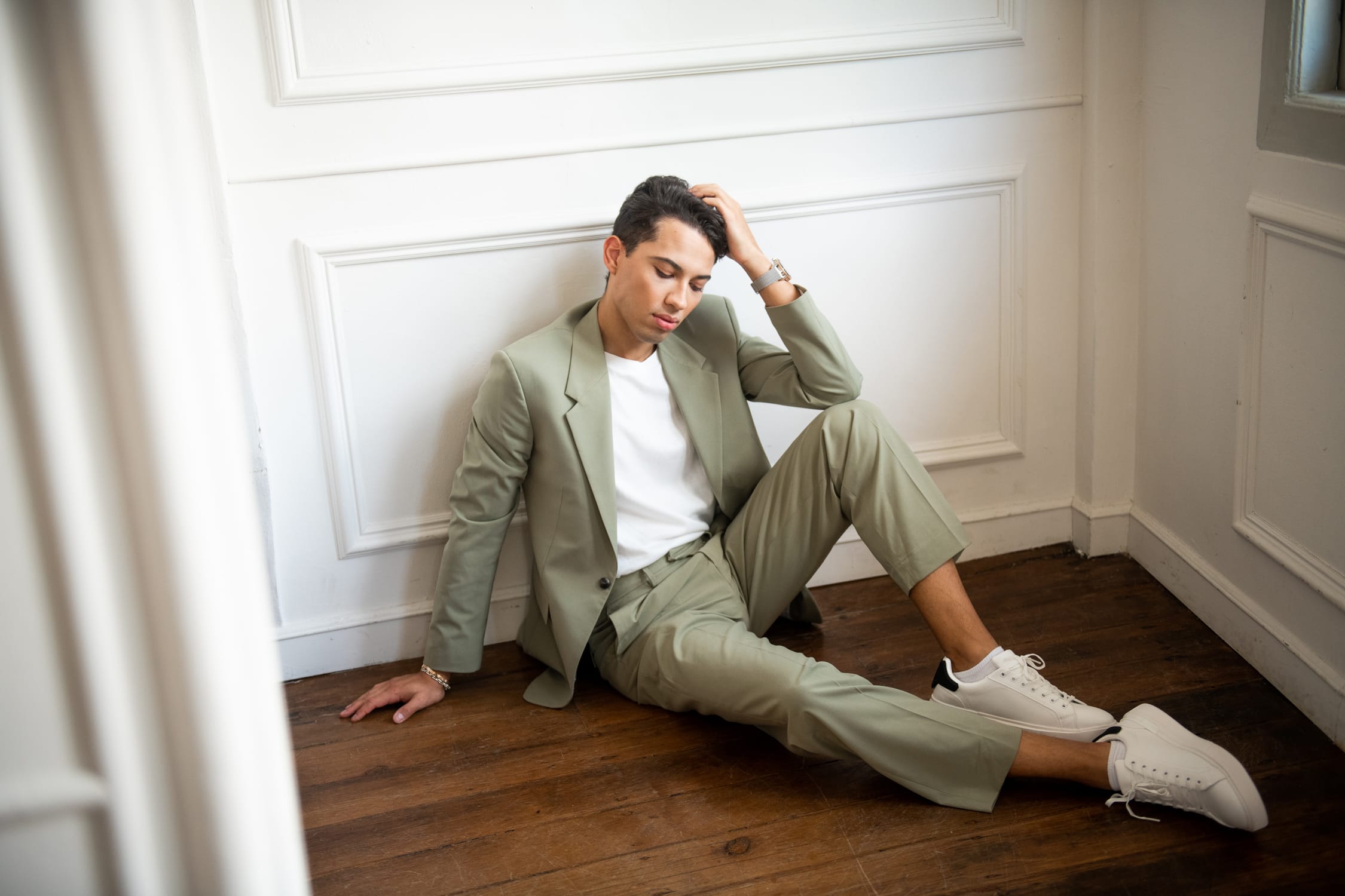 Man posing in a photography studio setting during a glamour photoshoot in Singapore, White Room Studio. Credit: White Room Studio Pte Ltd