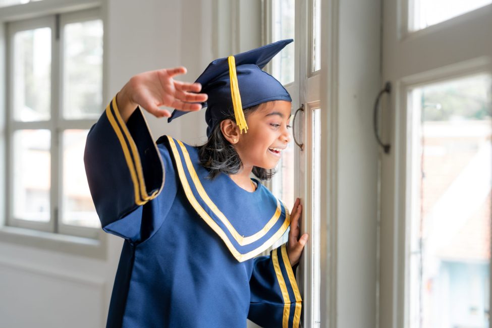 K2 Graduation Photoshoot of a little girl in her graduation gown in Singapore Family Photoshoot Singapore White Room Studio