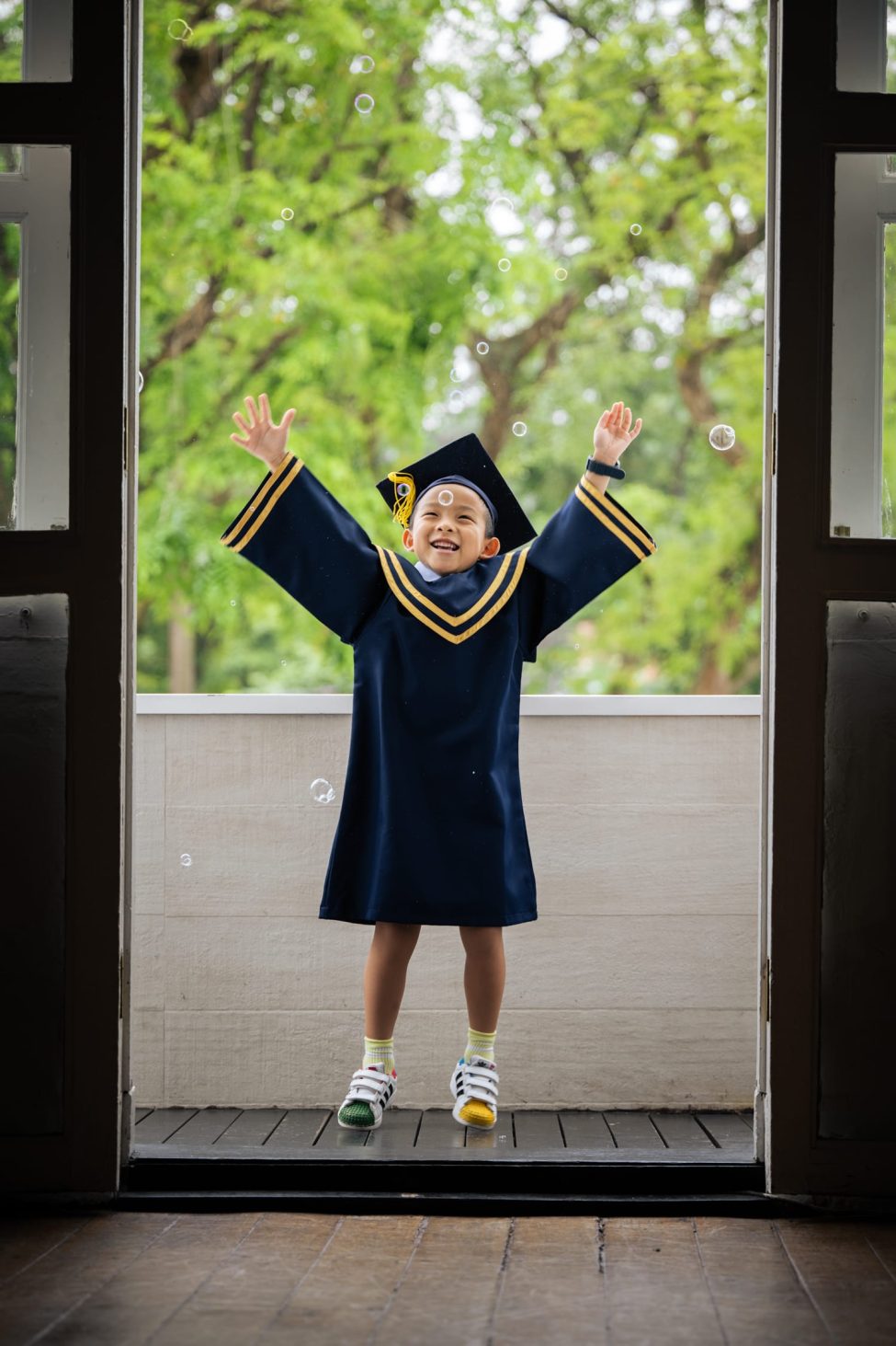 Boy in K2 kindergarten graduation gown and cap during a k2 kindergarten graduation photoshoot in Singapore Credit: White Room Studio