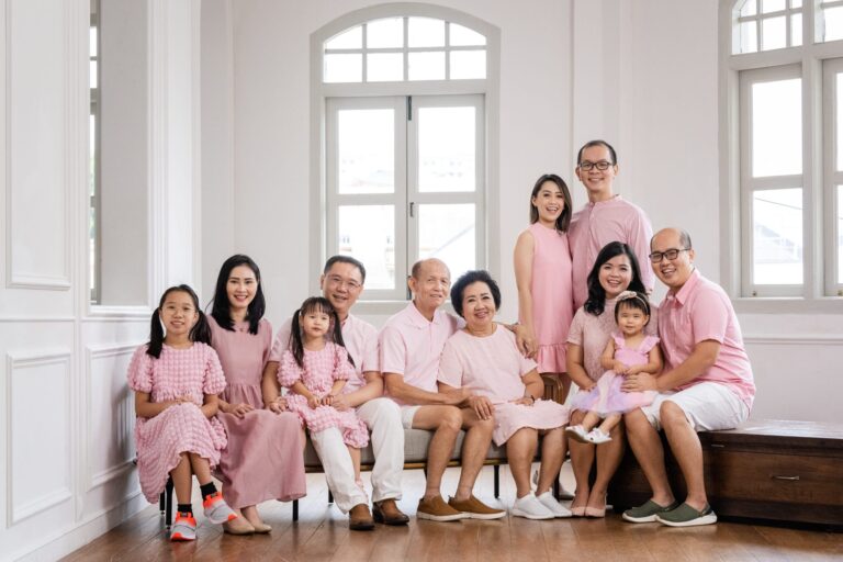 Multi generation family with parents and their children with kids ages ranging from toddler to teens in a photography studio setting during a multi generation family photoshoot in Singapore, White Room Studio. Credit: White Room Studio Pte Ltd