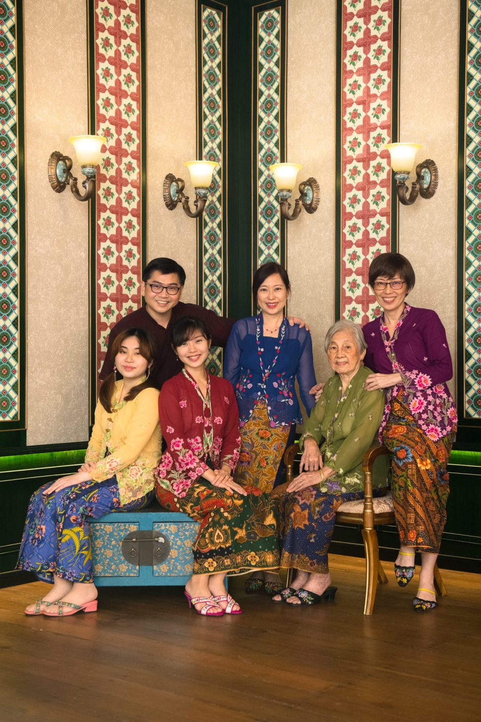 Family with parents and their children in Peranakan kebayas in a photography studio setting during a family photoshoot in Singapore, White Room Studio. Credit: White Room Studio Pte Ltd