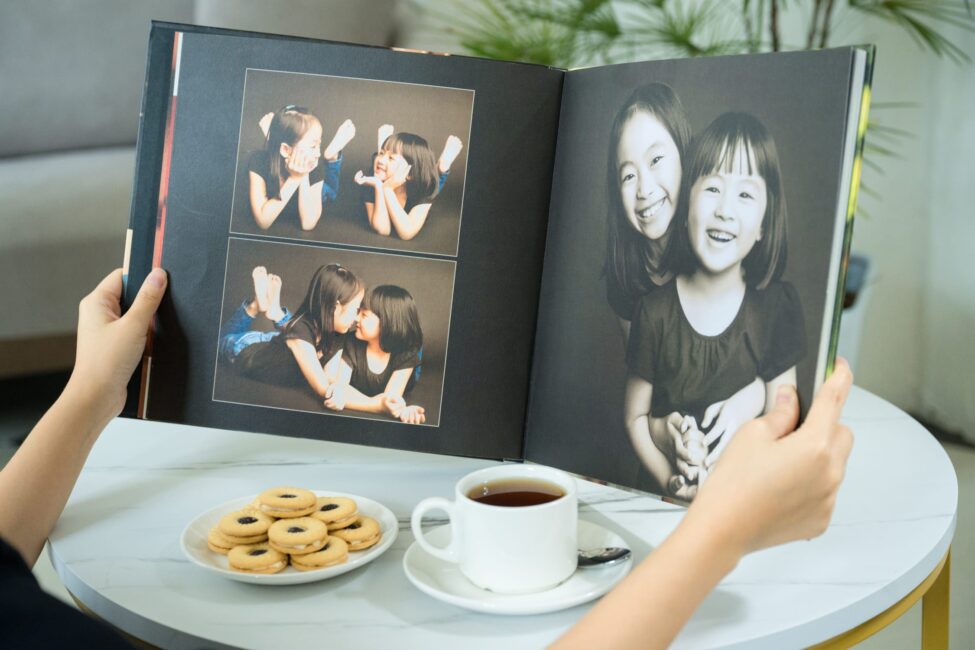 Premium coffee table book of a family with parents and their children with kids ages ranging from toddler to teens in a photography studio setting during a family photoshoot in Singapore, White Room Studio. Credit: White Room Studio Pte Ltd