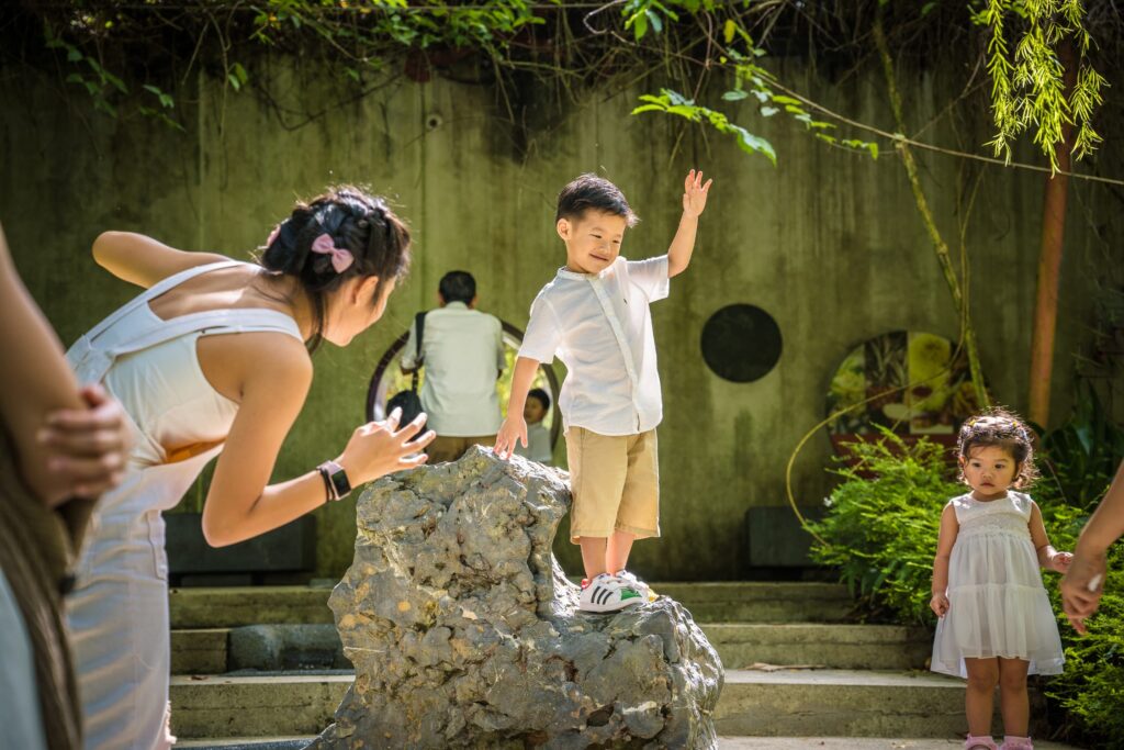 Professional Family & Multi Generation Photoshoot in Gardens by the Bay, Singapore Family with brother and sister in an outdoor setting during an outdoor family photoshoot in Singapore, Gardens by the Bay. Credit: White Room Studio Pte Ltd