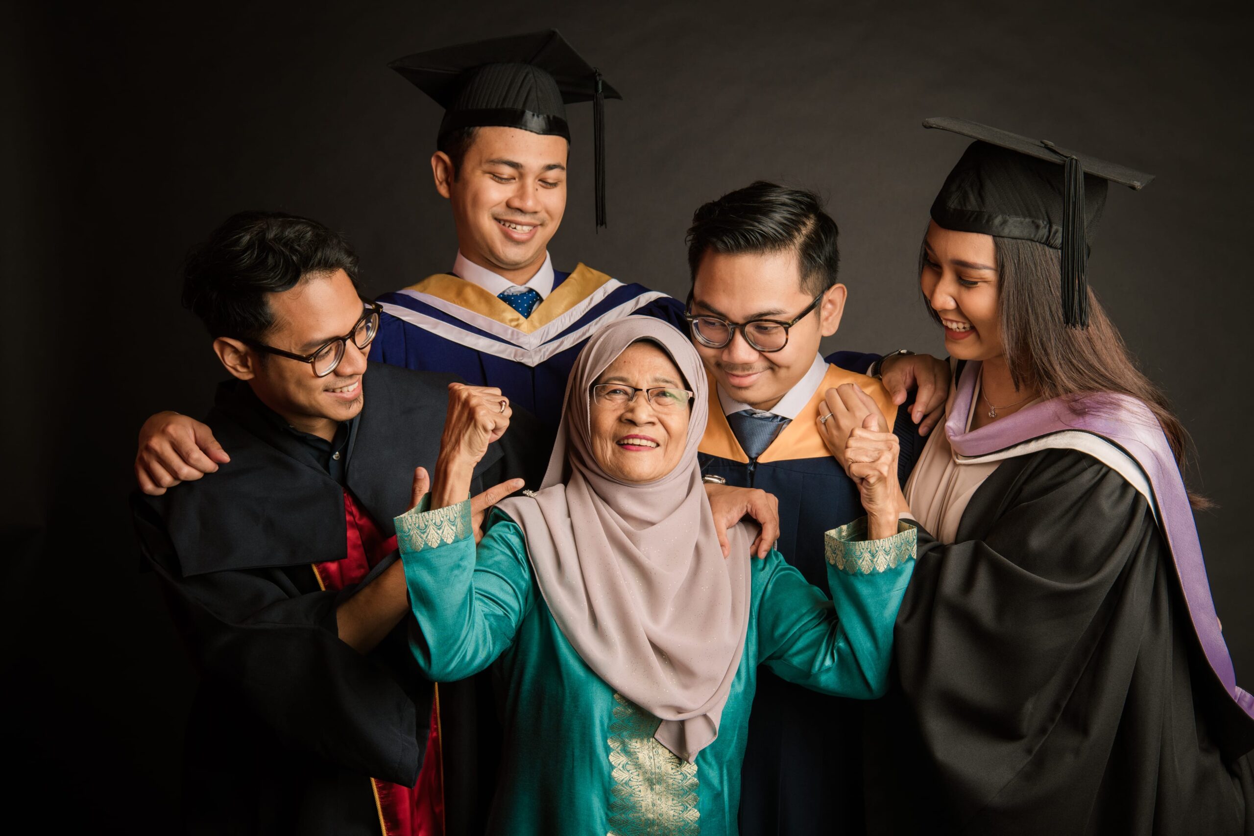 Family with parents and their children with kids in a photography studio setting during a family Hari Raya photoshoot in Singapore, White Room Studio. Credit: White Room Studio Pte Ltd