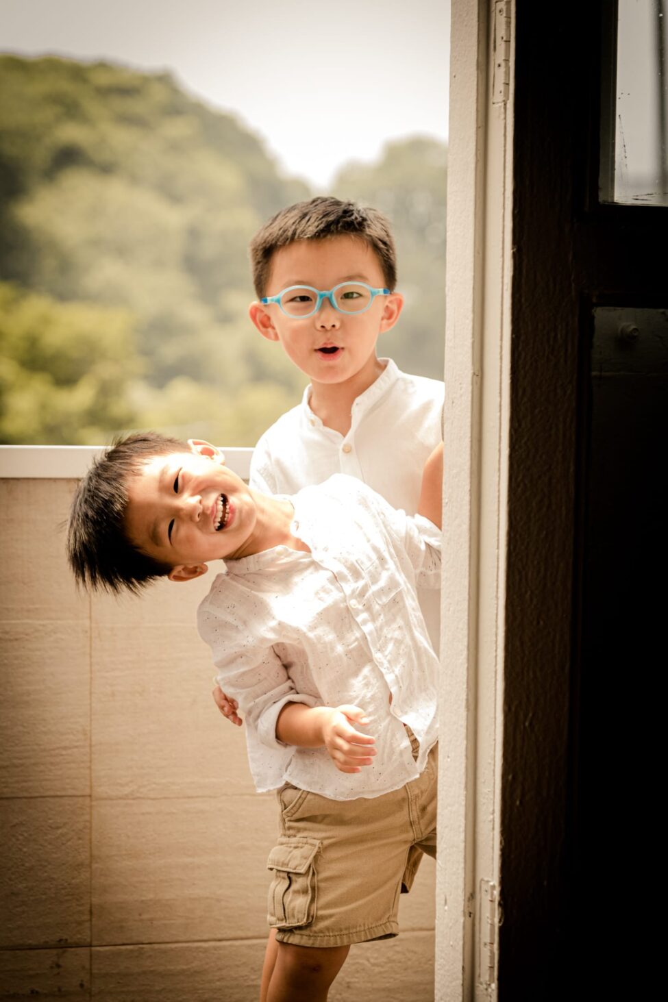 Family with parents and Two young kids (boys) in a photography studio setting during a family photoshoot in Singapore, White Room Studio. Credit: White Room Studio Pte Ltd