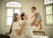 Family with parents and their one year old baby in a photography studio setting during a family photoshoot in Singapore, White Room Studio. Credit: White Room Studio Pte Ltd