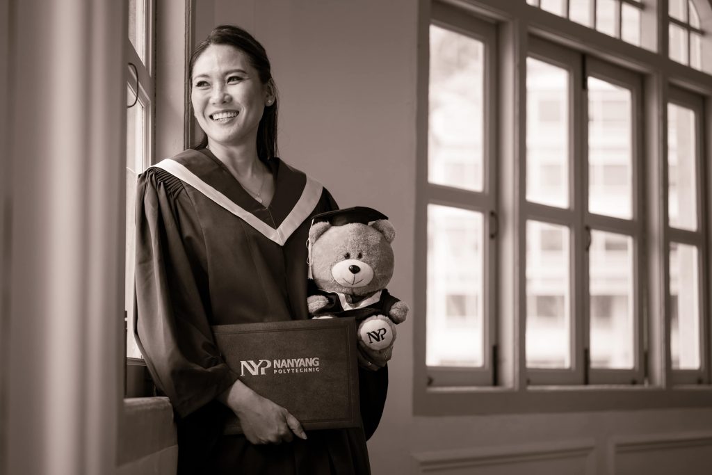 Graduate smiling during a graduation photoshoot at White Room Studio