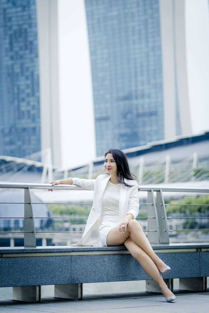 Woman posing for professional portrait during an outdoor corporate photoshoot in Singapore, Fullerton Bay. Credit: White Room Studio Pte Ltd