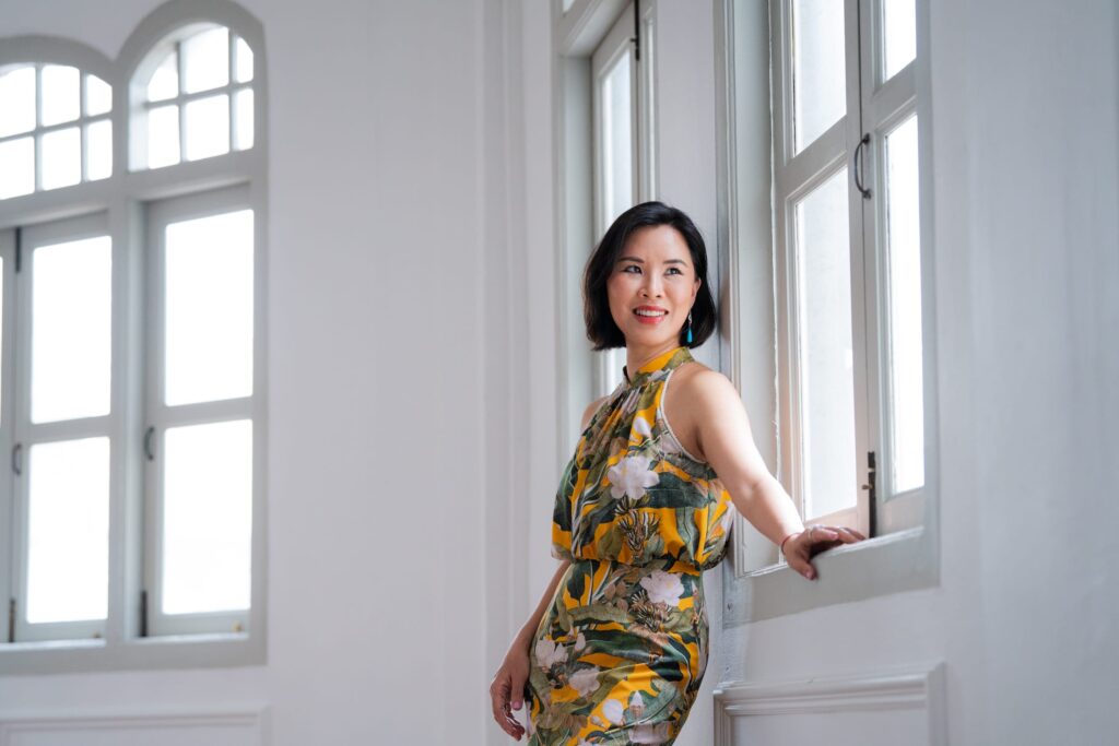 Professional female public speaker posing for headshot in a photography studio setting during a corporate photoshoot in Singapore, White Room Studio. Credit: White Room Studio Pte Ltd