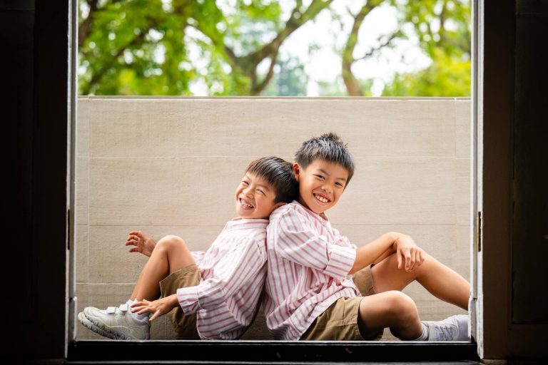 Best Singapore family photo studio, Family with parents and their children with kids ages ranging from toddler to teens in a photography studio setting during a family photoshoot in Singapore, White Room Studio. Credit: White Room Studio Pte Ltd