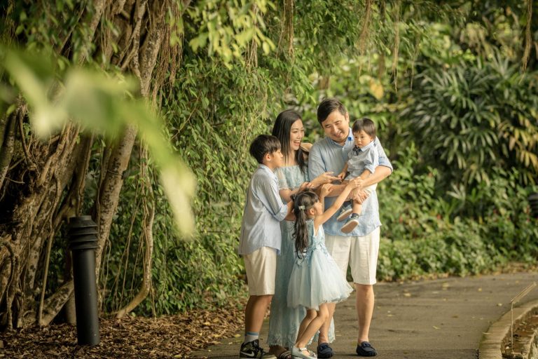 Family with parents and their children with kids ages ranging from toddler to teens in a photography outdoor setting during an family photoshoot in Singapore. Credit: White Room Studio Pte Ltd