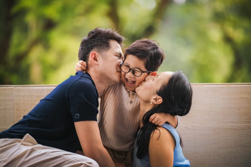 Best Singapore family photo studio, Family with parents and their children with kids ages ranging from toddler to teens in a photography studio setting during a family photoshoot in Singapore, White Room Studio. Credit: White Room Studio Pte Ltd