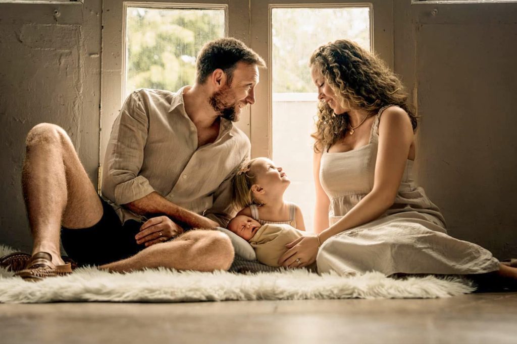 Singapore family photo studio, Family with parents and their children with kids ages ranging from toddler to teens in a photography studio setting during a family photoshoot in Singapore, White Room Studio. Credit: White Room Studio Pte Ltd