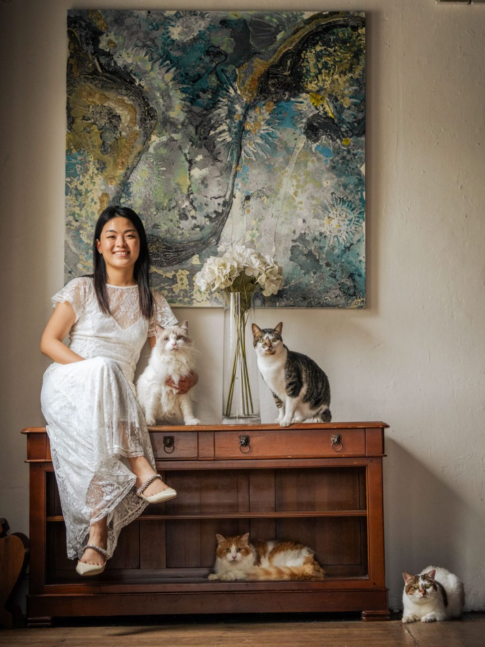 Pet Portrait Photography Singapore of lady with four cats in natural light photo studio in blue painting corner at White Room Studio, 219 River Valley Road Singapore