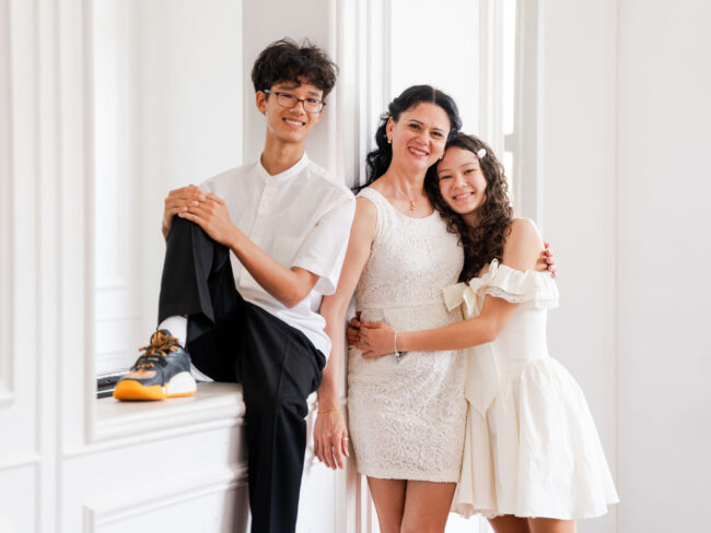 Family in a photography studio setting during a family photoshoot in Singapore, White Room Studio. Credit: White Room Studio Pte Ltd
