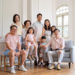 Multi-generation family with parents and their children with kids ages ranging from toddler to teens in a photography studio setting during a family photoshoot in Singapore, White Room Studio. Credit: White Room Studio Pte Ltd