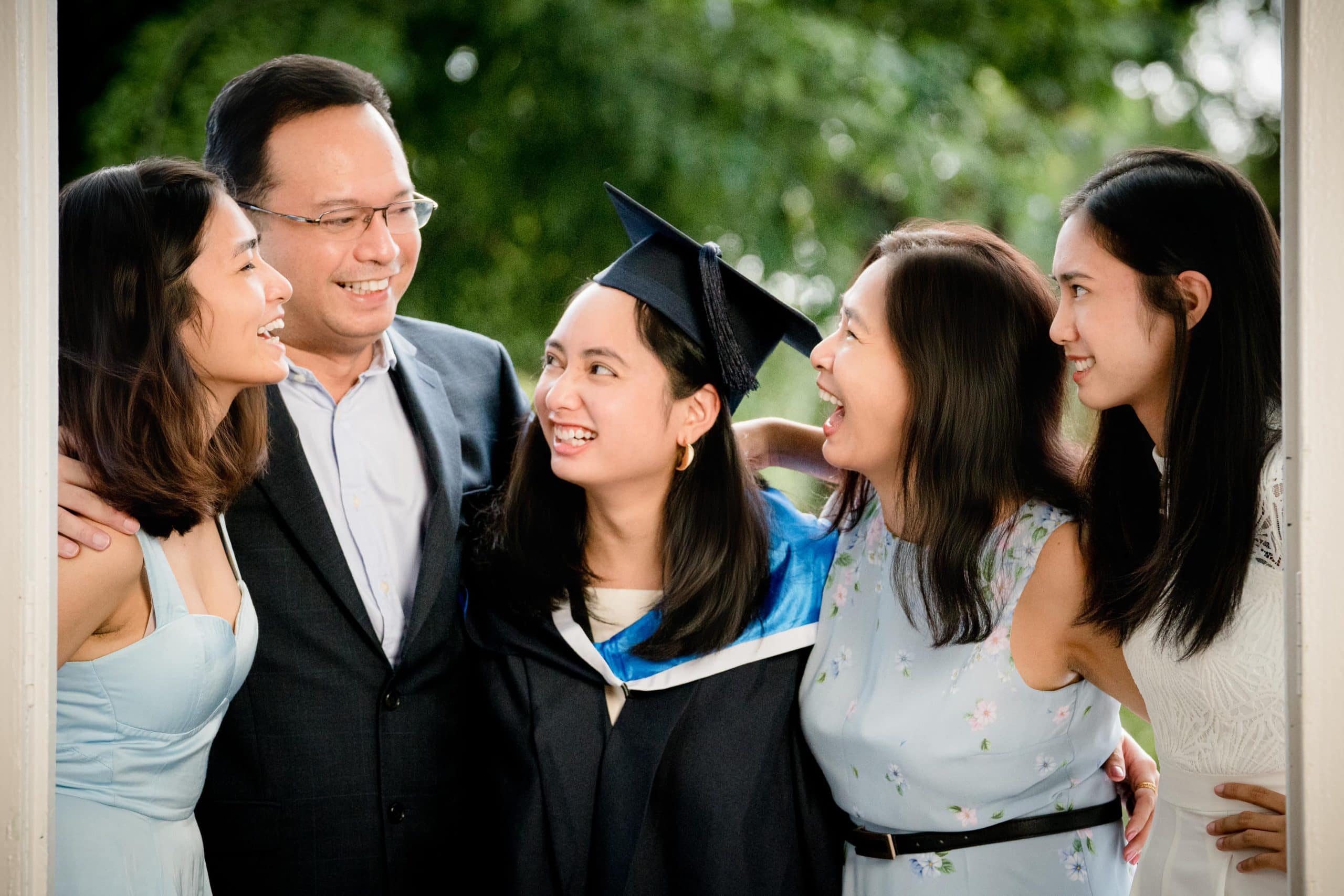 Graduation photoshoot of three daughters and parents in natural light photo studio at White Room Studio, 219 River Valley Road Singapore