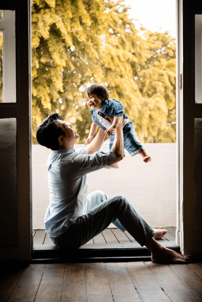 Singapore family photo studio, Family with parents and their children with kids ages ranging from toddler to teens in a photography studio setting during a family photoshoot in Singapore, White Room Studio. Credit: White Room Studio Pte Ltd