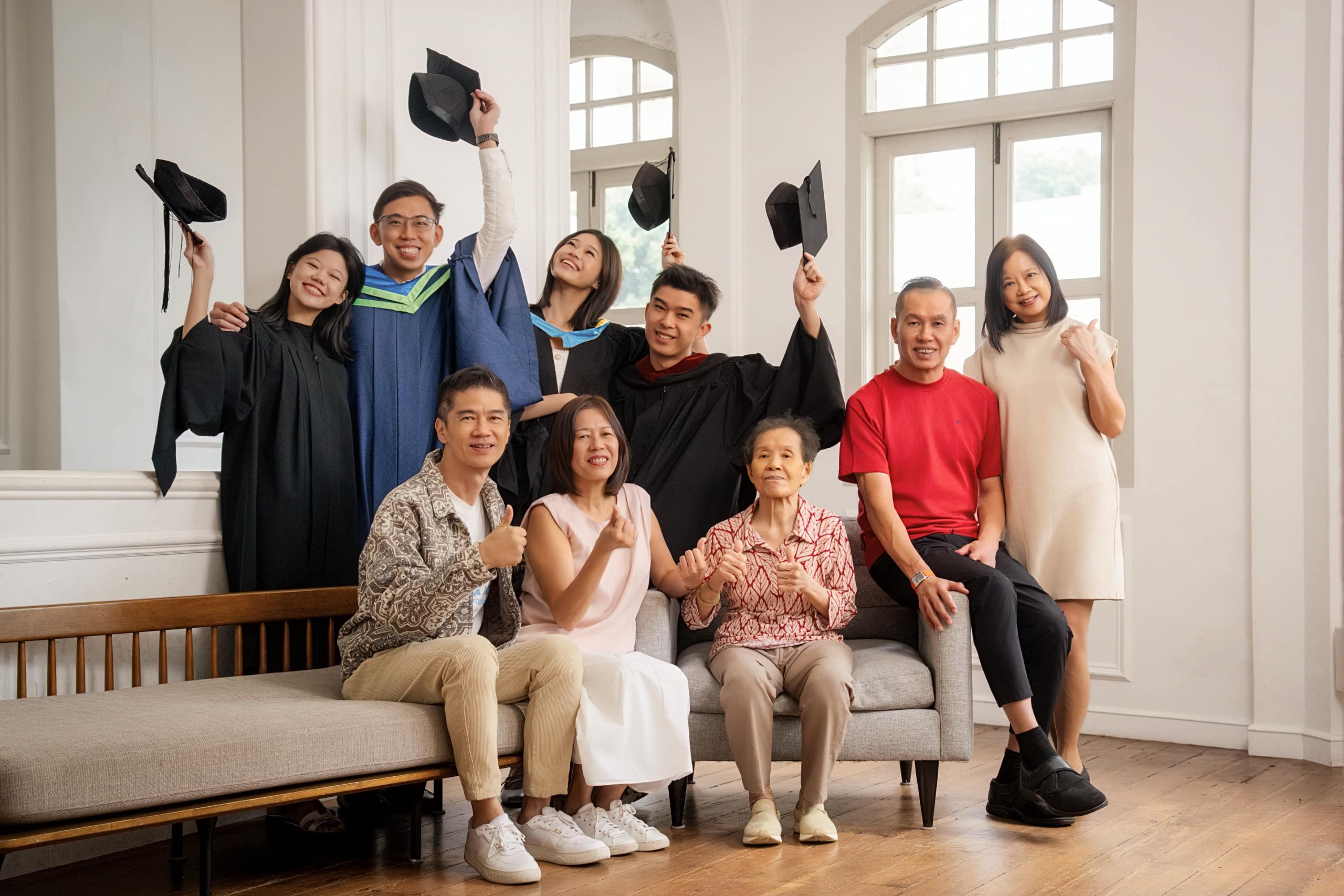 Multigen Graduation photoshoot of graduates in gown and cap with parents and grandparents in natural light photo studio at White Room Studio, 219 River Valley Road Singapore