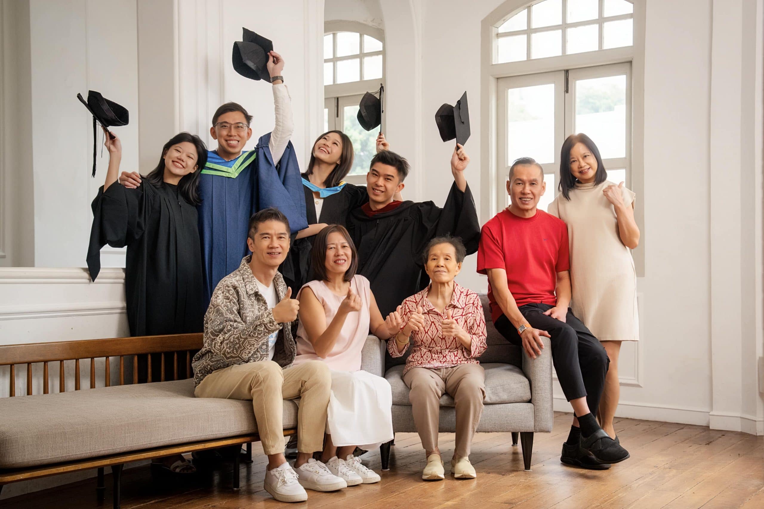 Multigen Graduation photoshoot of graduates in gown and cap with parents and grandparents in natural light photo studio at White Room Studio, 219 River Valley Road Singapore