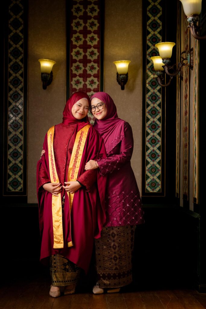 Graduation photoshoot of graduate in gown and cap in natural light Peranakan photo studio at White Room Studio, 219 River Valley Road Singapore