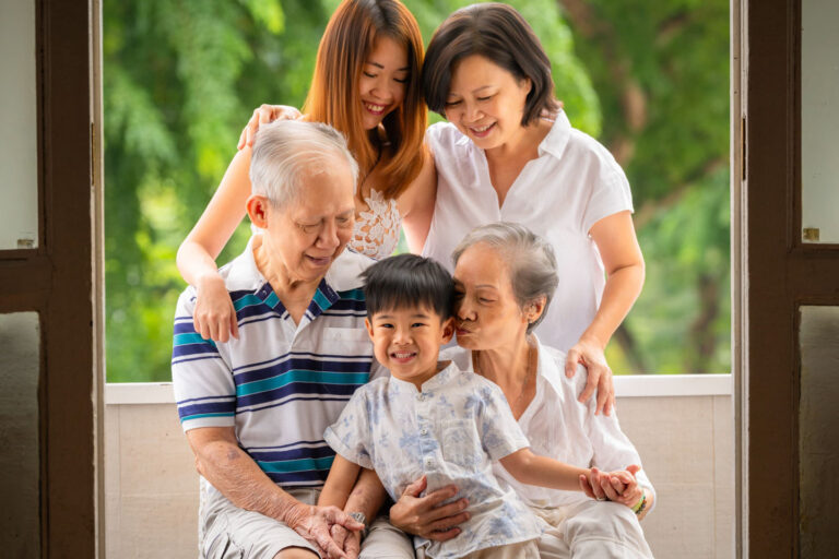 Family with parents and their toddler in a photography studio setting during an family photoshoot in Singapore. Credit: White Room Studio Pte Ltd